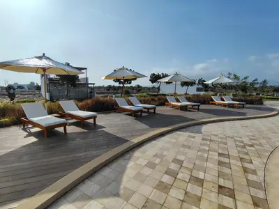 a row of chairs and umbrellas on a patio at Casa en Asia con piscina in Asia