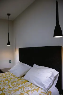 a bedroom with a bed with white pillows at PRANA in Huancayo