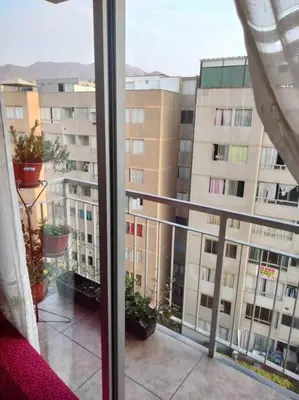 a view of a large building from a window at Tait's House - Cómodo departamento Dúplex - Ate in Lima