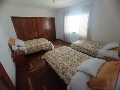 a hotel room with two beds and a window at Inti Wasi in Cusco