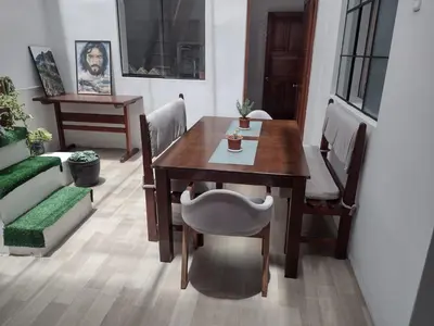 a dining room with a wooden table and chairs at Inti Wasi in Cusco