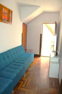 a blue couch in a living room with a window at Inti Wasi in Cusco