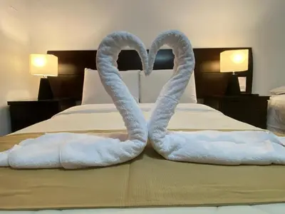 two swans made out of towels on a bed at Plaza Mayor Lima in Lima