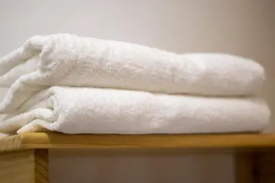 a pile of white towels sitting on a table at Plaza Mayor Lima in Lima