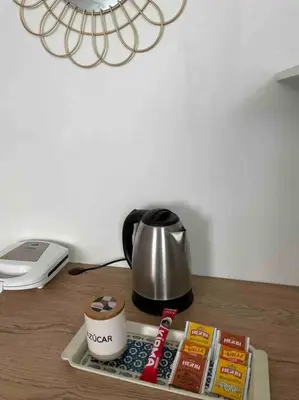 a table with a coffee pot and a tea kettle at Huancayo Suite 4-Cómodo MiniDpto 2 camas in Huancayo