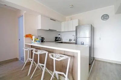 a kitchen with white cabinets and a refrigerator at Beautiful floor 9th apartment Pool Gym Barranco in Lima