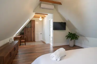 a bedroom with a white bed and a staircase at Casa Cáceres in Lima