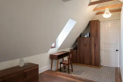 a room with a staircase with a desk and a door at Casa Cáceres in Lima