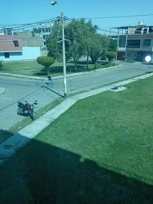 a motorcycle parked on the side of a street at Gardella House, Casa - Hotel in Ica