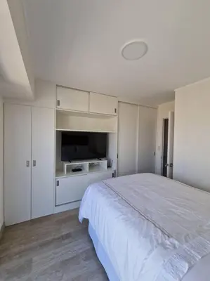 a white bedroom with a large bed and white cabinets at Barranco Aparment Luxury in Lima