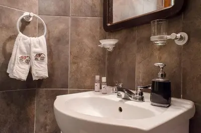 a bathroom with a white sink and a mirror at Cusco Bed and Breakfast in Cusco