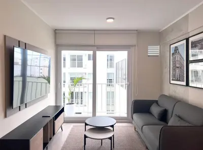 a living room with a couch and a table at Peruvian Apartments Miraflores in Lima