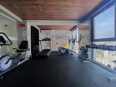 a gym with several treadmills and bikes in a room at Peruvian Apartments Barranco 2004 in Lima