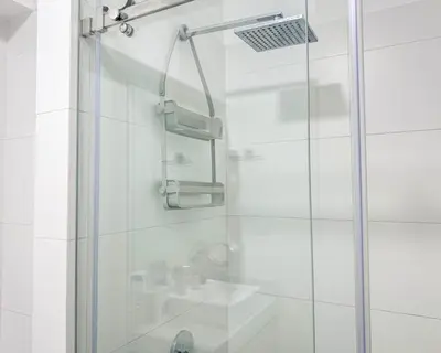 a shower with a glass door in a bathroom at Peruvian Apartments Barranco 1606 in Lima