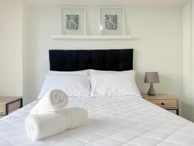 a bedroom with a white bed with towels on it at Peruvian Apartments Barranco 1606 in Lima