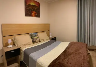 a bedroom with a large bed with a wooden headboard at Mousse PL in Lima