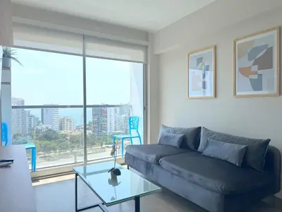 a living room with a couch and a glass table at Peruvian Apartments Barranco 1609 in Lima