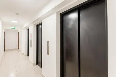 a hallway with black doors and white walls at Peruvian Apartments Barranco 1806 in Lima