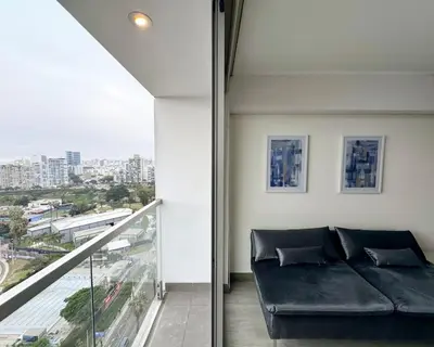 a living room with a couch and a balcony at Peruvian Apartments Barranco 1806 in Lima