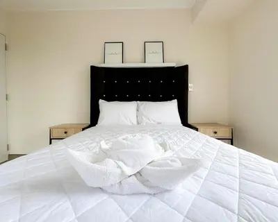 a white bed with two cards on top of it at Peruvian Apartments Barranco 904 in Lima