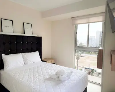 a bedroom with a bed with two stuffed animals on it at Peruvian Apartments Barranco 904 in Lima