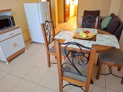 a kitchen with a table with a plate of fruit on it at Sol de Paracas Apart Hotel Pisco in Pisco