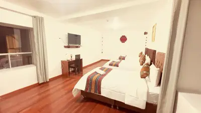 a bedroom with a bed and a television in it at Casona Libertrek Inn in Cusco