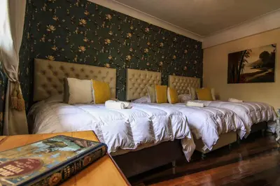 two beds sitting next to each other in a bedroom at Bamba House Cusco in Cusco
