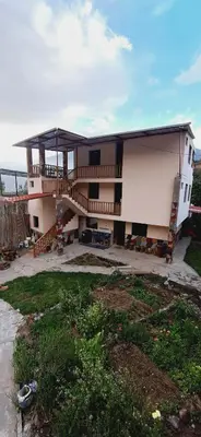 a large building with a porch and a balcony at Hotel El Gran Valletero in Cotahuasi