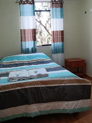 a bedroom with a bed with towels on it at Hotel El Gran Valletero in Cotahuasi