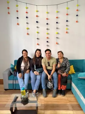 a group of people sitting on a couch at Qori Garden Apartment in Cusco