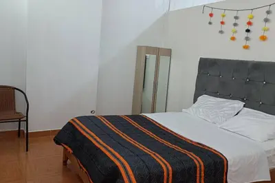 a bedroom with a bed with a blanket on it at Qori Garden Apartment in Cusco