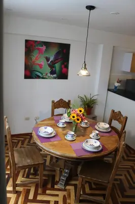 a dining room table with chairs and a dining at El colibrí de San Blas in Cusco