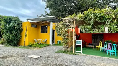 a colorful house with a table and chairs in front of it at Serenity Lodge in Ica