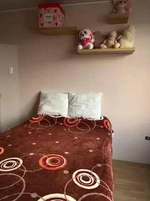 a bedroom with a bed with stuffed animals on a wall at Espacio para ti y tu familia in Lima
