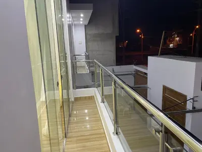 a balcony with a glass railing and a stair case at Hurin Hotel in Ica