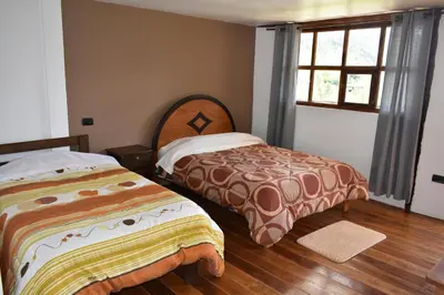a bedroom with two beds and a window at CasaNostra Choquequirao in Cachora