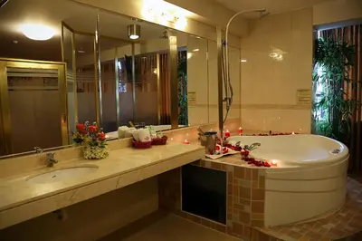 a bathroom with a tub and a sink and a mirror at Hotel Princesa in Lima