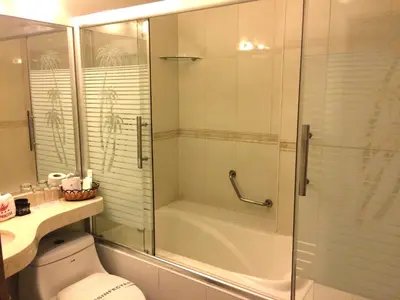 a bathroom with a shower and a toilet with a glass door at Hotel Princesa in Lima