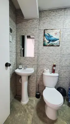 a bathroom with a toilet and a sink at Sanbar House in San Bartolo