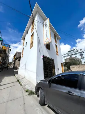 a car parked in front of a white building at Golden Paris Hotel 