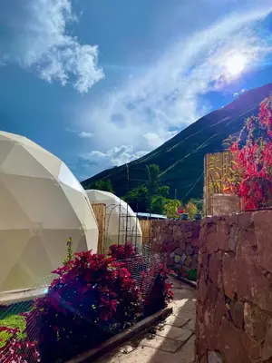 a view of a garden with flowers and a mountain at MISKI SAMAY DOMO BOUTIQUE in Urubamba
