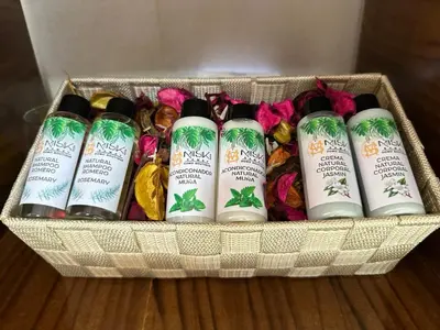 a basket with four bottles of hair products on a table at MISKI SAMAY DOMO BOUTIQUE in Urubamba