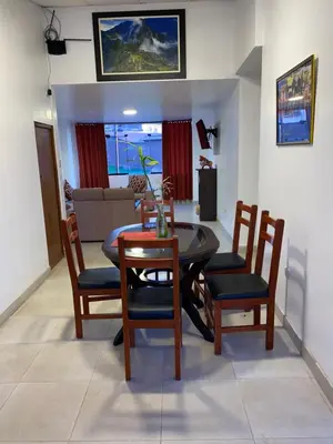 a dining room table and chairs in a living room at Adriano's Deluxe Apartments 3 in Cusco
