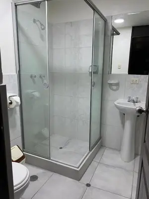 a bathroom with a shower and a toilet and a sink at Adriano's Deluxe Apartments 3 in Cusco