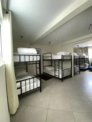 a room with four bunk beds in it at The Point Miraflores, Lima in Lima