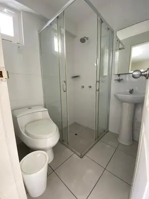a bathroom with a toilet and a glass shower at The Point Miraflores, Lima in Lima