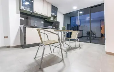 a kitchen with a table and chairs in a room at YURAQ WASI Hotel/Restobar in Huánuco