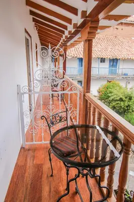 a black bench sitting on a balcony at QORI, apartamento nuevo Centro Histórico de Cusco, Cuesta San Blas 561 in Cusco
