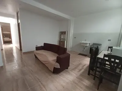 a living room with a couch and a table at CARDOS HOSTAL in Pisco